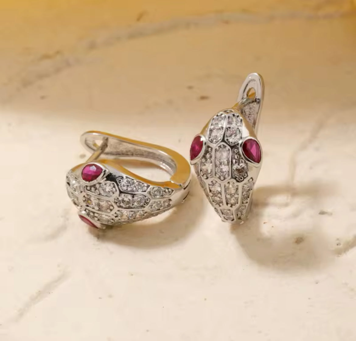Snake hoops with ruby cz stones.